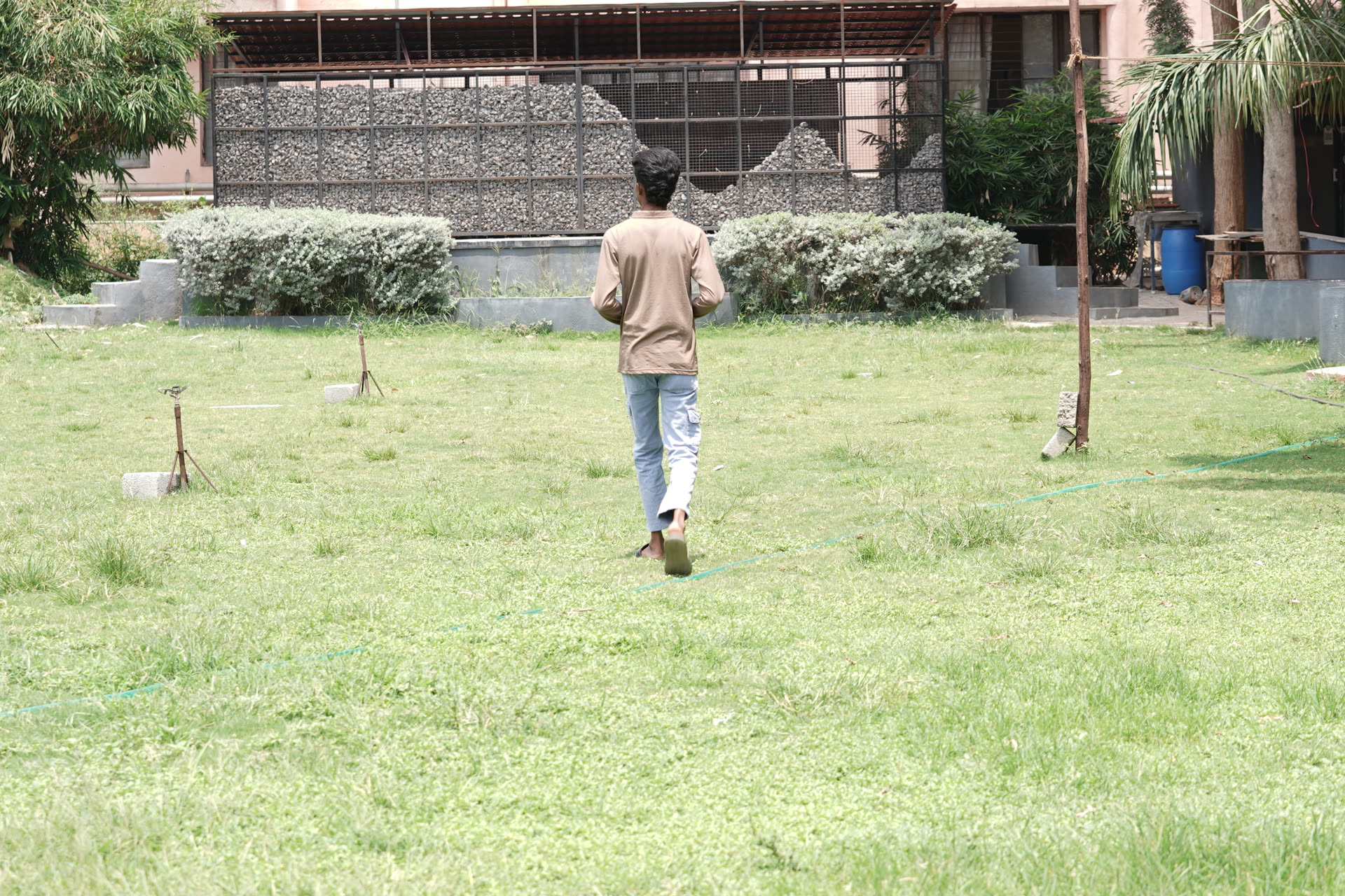 Student walking on campus lawn